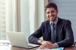 https://i2.wp.com/m.foolcdn.com/media/dubs/images/smiling_man_in_business_suit_at_laptop_GettyIma.original.jpg